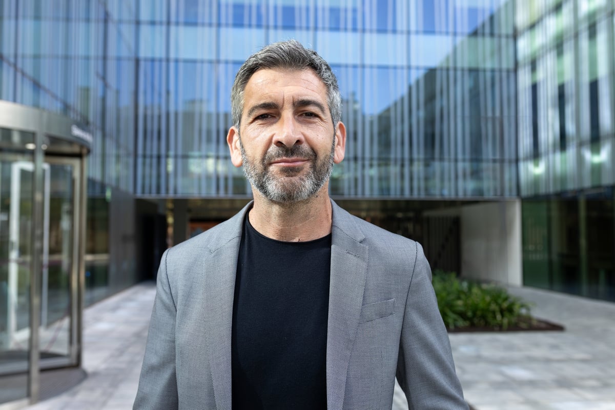 Confident businessman smiling outside office building