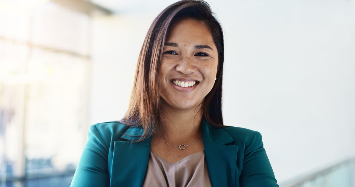 Happy confident businesswoman in corporate setting