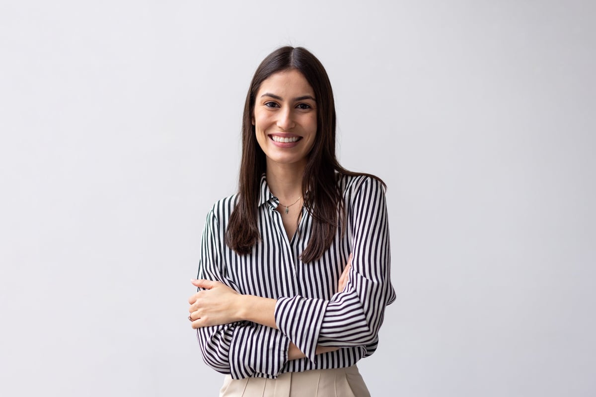 Portrait of a confident young businesswoman smiling with arms crossed