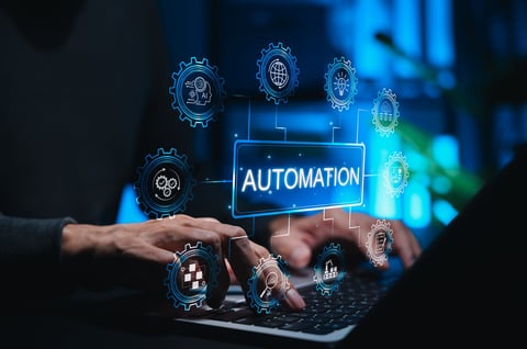 Automation concept in technology and business. Person using laptop while gear icons symbolizing AI, workflow automation, data analysis, cloud computing, and smart industry surround AUTOMATION label.